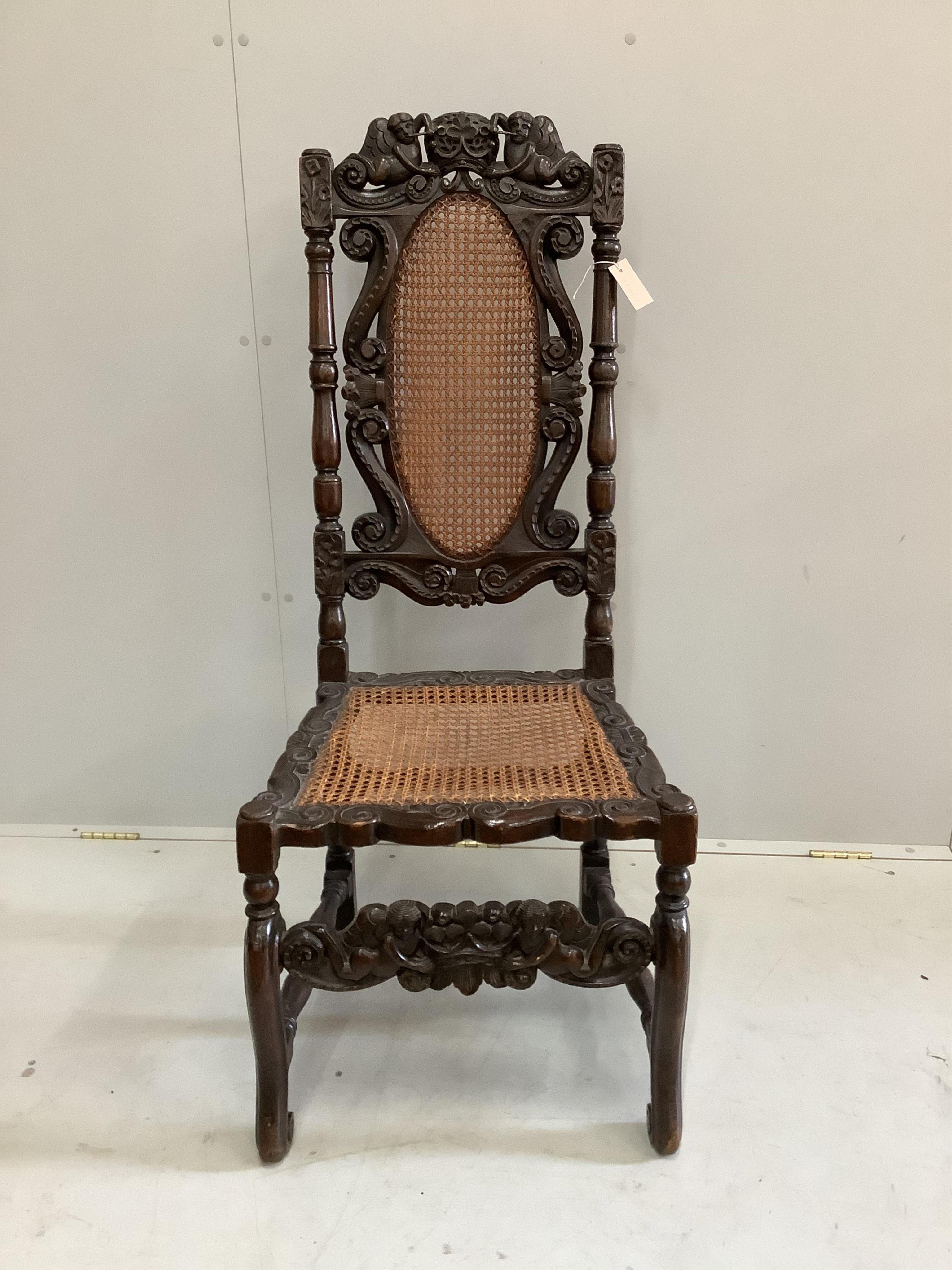 A Charles II carved walnut caned seat and back dining chair, height 124cm. Condition - fair